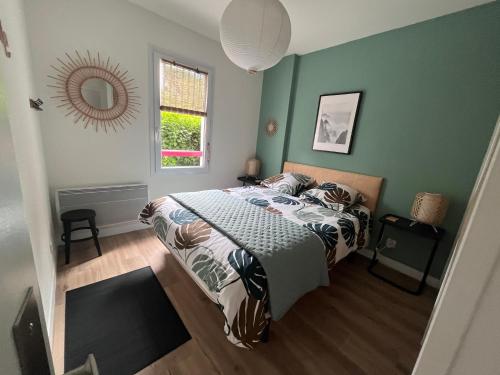 圣让-德吕兹Urdina的一间卧室配有一张带绿色墙壁和镜子的床