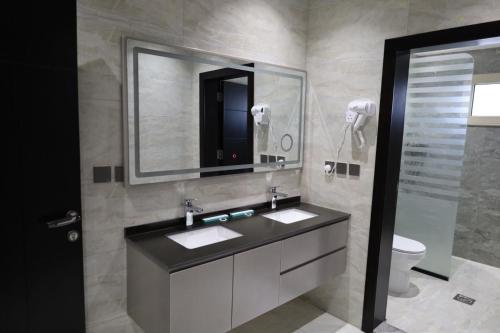 Al Namasقمم بارك Qimam Park Hotel 6的一间带水槽、镜子和卫生间的浴室