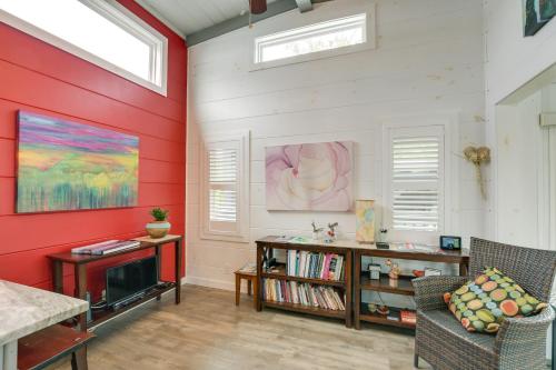 弗拉特罗克Chic Flat Rock Tiny Home with Community Pool Access!的客厅设有红色的墙壁和电视。