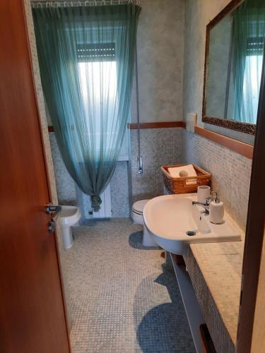 奇维塔韦基亚MARE FUORI APARTMENT的一间带水槽、卫生间和镜子的浴室