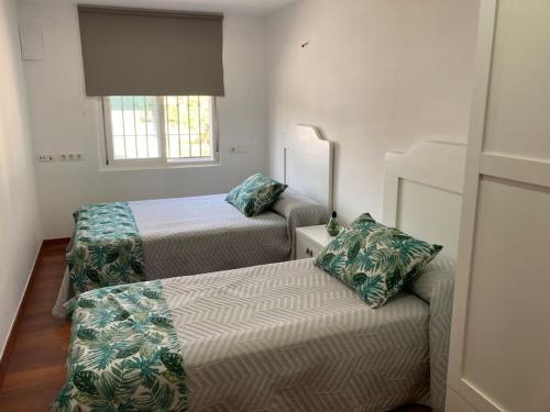 莫特里尔“Soleado” Casa rural con piscina的一间卧室设有两张床和窗户。