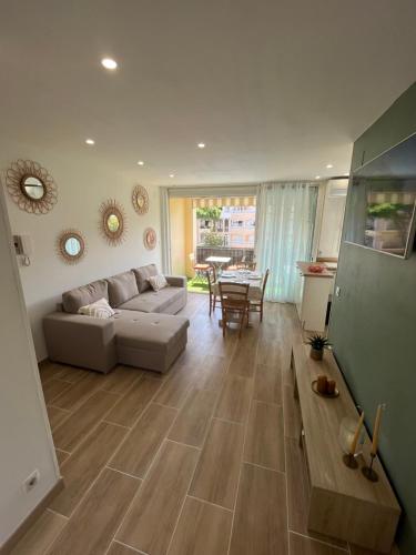 艾姆布里亚布拉瓦Appartement 1 chambre climatisé avec 3 piscines à 200 m de la plage的客厅配有沙发和桌子