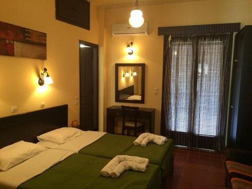 SpílionGreen Hotel - Maravel Botanical Garden的一间卧室配有一张床,上面有两条毛巾