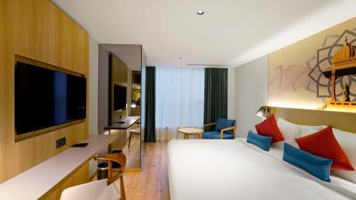 班加罗尔Aiden by Best Western Hennur的一间酒店客房,配有一张床和一台电视