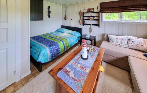 吕瑟希尔Nice Home In Lysekil With Sauna的一间小卧室,配有一张床和一张茶几
