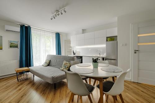 绿山城Apartamenty MM - Chmielna的客厅配有桌子和沙发