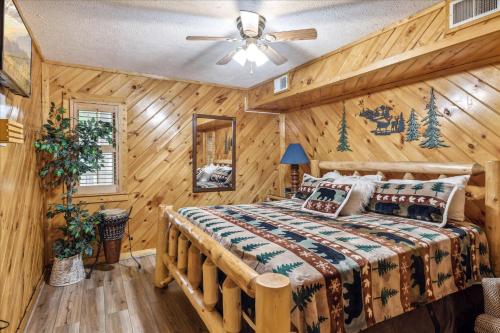 赛维尔维尔Smokey Max Chalet的小木屋卧室配有床和吊扇