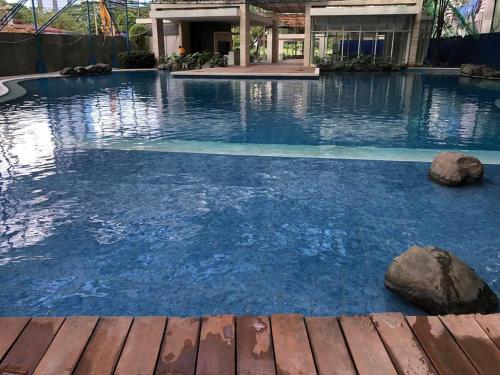 马尼拉Kasara Urban Resort and Residences的大楼内的一个蓝色海水游泳池