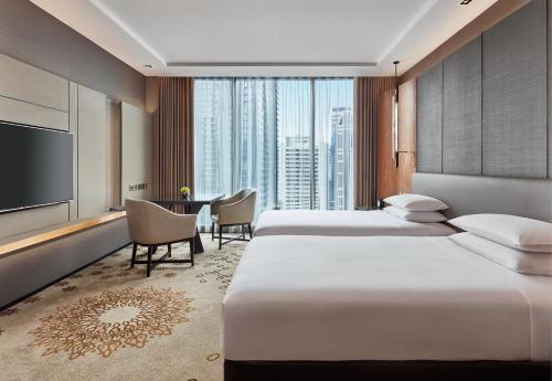 曼谷曼谷素坤逸凯悦酒店的酒店客房设有两张床和一台平面电视。