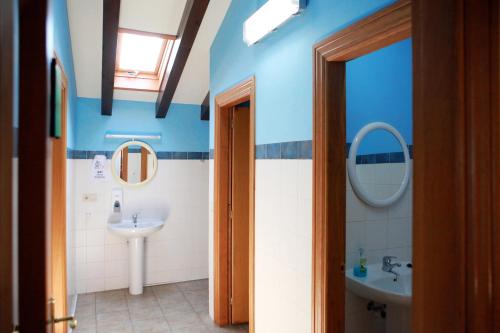 Maya del BaztánAmaiurko Aterpea的浴室设有蓝色的墙壁、水槽和镜子