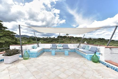 圣特奥多罗Villa Minda的庭院配有蓝色和白色家具和白色天篷