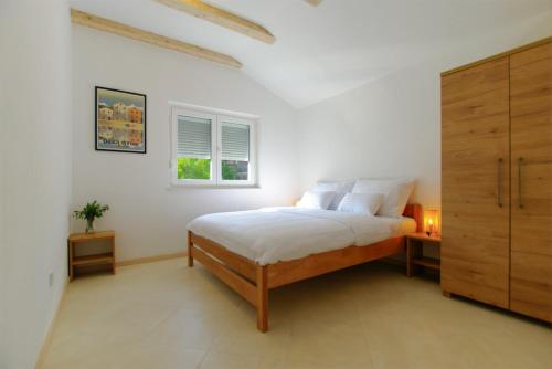 萨利Apartmani Porat Sali的白色的卧室设有床和窗户