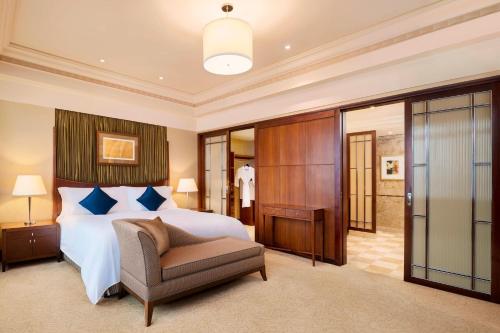 上海上海红塔豪华精选酒店的一间卧室,卧室内配有一张床和一把椅子