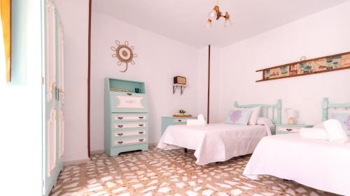 卡索拉Casa rural mirador de sole的一间带两张床和梳妆台的卧室