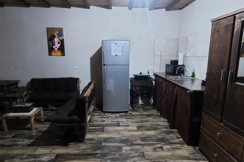 阿拉胡埃拉Casa Rústica Pura Vibra的一间位于客房角落的带冰箱的厨房