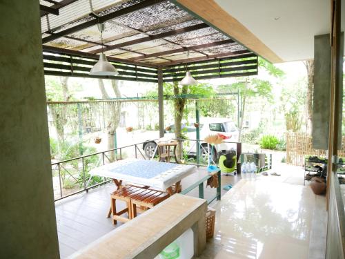 Ban Pa LauTime Pala-U Garden Villa (Noncee House)的阳台的天井配有桌椅