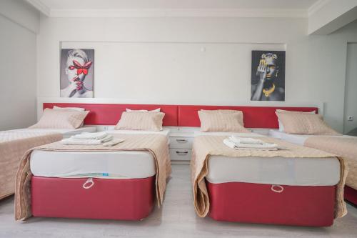 伊兹密尔YAŞAM HOTEL的红色和白色的客房内的两张床