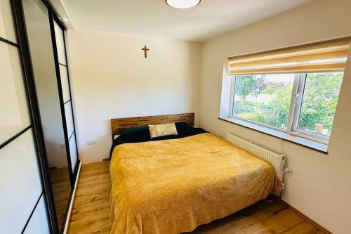 诺丁汉Stunning 3 bed house sleeps6的卧室配有一张床,墙上有十字架