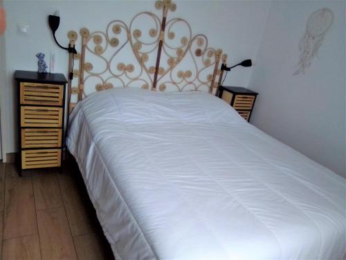 ValescureT3 Duplex 65 m2 6 lits 2 SDB terrasse clim garage的一间卧室配有一张白色床和金色床头板