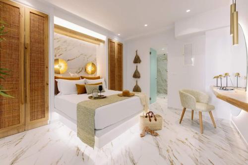 阿吉奥斯普罗科皮奥斯Venus Suite with Hot Tub的一间卧室配有一张床、一张桌子和一个水槽