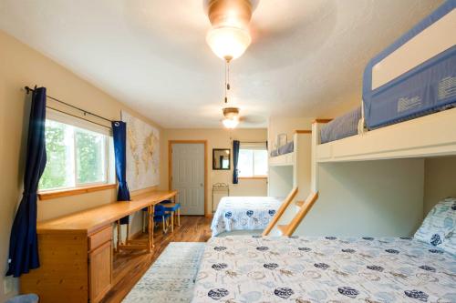 Waterfront Johnson Lake Getaway with Fire Pit!的一间卧室配有两张双层床和一张书桌