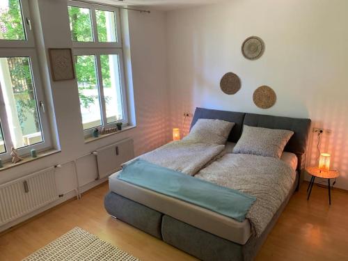 巴特罗森菲尔德Ferienwohnung Parkblick - Balkon 77m2的一间卧室配有带2个枕头的床和2个窗户。