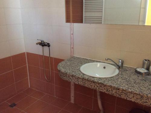 鲁塞民族酒店的一间带水槽和淋浴的浴室