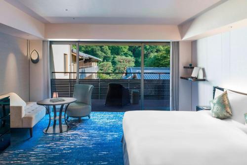 京都京都翠岚豪华精选酒店的酒店客房设有一张床和一个阳台。