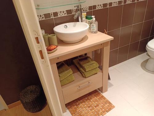 ChadracLa maison des roses的浴室配有盥洗盆和带毛巾的台面。