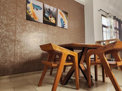 洛美KADIDJA APARTMENTS & SUITES Akodessewa的一张木桌和椅子