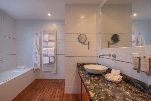 坡隆维茨普尔扎伊帕拉格酒店的白色的浴室设有水槽、浴缸和水槽。