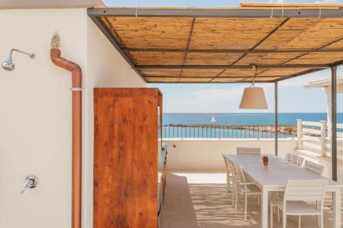 加利波利Dimora San Felice Il Fico的一间设有桌子的海景用餐室