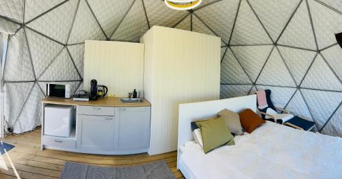 LoveLand Farm Kupolai的一间卧室配有带一张床和一张书桌的帐篷