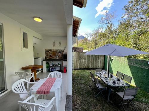 圣塞巴斯蒂安Casa Clean e Comfort, a mais completa de Paúba的一个带桌子和遮阳伞的庭院