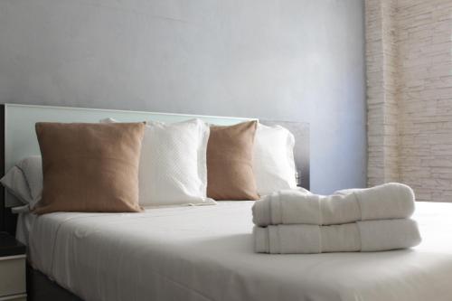 圣波拉Apartamento Bahía的一张带枕头和毛巾的白色床