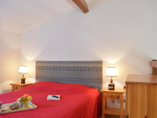 圣艾格夫Appartement Saint-Aygulf, 2 pièces, 4 personnes - FR-1-226A-13的一间卧室配有一张红色的床,上面有水果盘