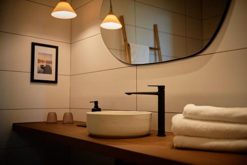 巴古尔L'Aixart Aiguablava Hotel的浴室配有盥洗盆、镜子和毛巾