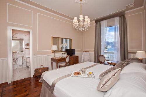 圣玛格丽塔-利古雷米拉梅尔大酒店的一间卧室配有一张床,上面放着一个食物托盘