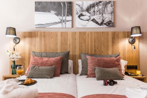 帕斯底拉卡萨Hotel Grand Pas的一间卧室配有红色和灰色枕头的床