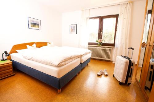 利普施塔特Ferienwohnung的一间卧室,里面放一张床和行李箱