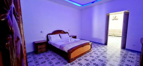 伊斯基亚Torrione Maison的紫色墙壁客房里一间卧室,配有一张床