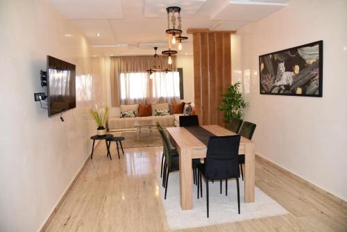 乌季达RAWAN RESIDENCY的用餐室以及带桌椅的起居室。