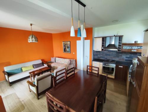 奥赫里德Villa Paradiso的厨房以及带橙色墙壁的起居室。