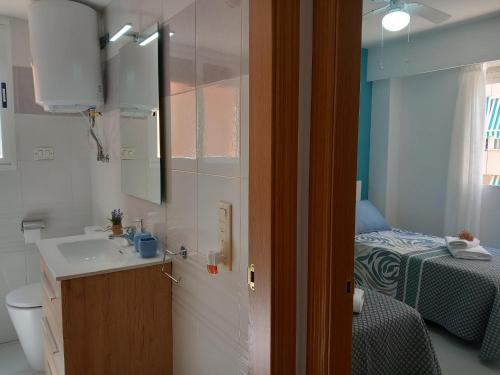 甘迪亚Caballito de mar, parking, AC y fibra VT-52619-V的一间带水槽的浴室和一间带一张床的卧室