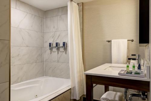 索罗尔德福朋喜来登圣凯瑟琳尼亚加拉大套房酒店的带浴缸和盥洗盆的浴室