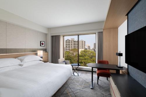 东京东京喜来登米亚科酒店的配有一张床、一张书桌和一扇窗户的酒店客房
