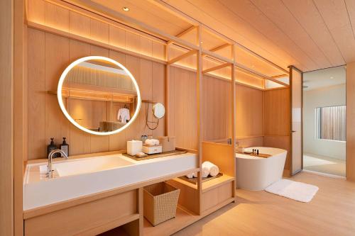 三亚三亚泰康之家度假酒店·臻品之选 (万豪旗下原木设计酒店)的一间带水槽和镜子的浴室