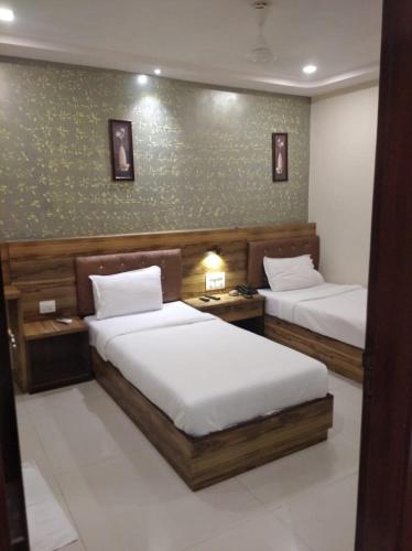 孟买Orange International-SANTACRUZ的一间卧室设有两张床和绿色的墙壁