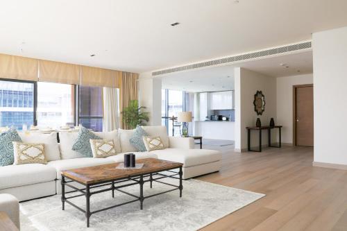 迪拜Nasma Luxury Stays - City Walk Building 5的客厅配有白色的沙发和桌子