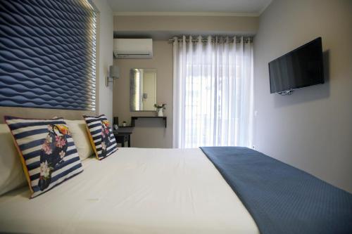 纳夫普利翁Ioanna's Luxury Two Bedroom Apartment的卧室配有一张白色大床和电视。